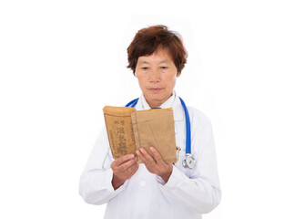 Doctor in white coat in front of white background is reading and studying