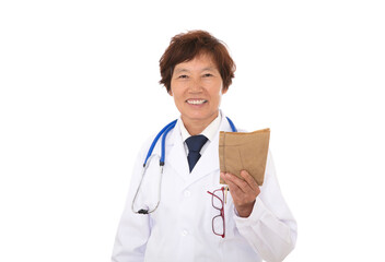 A doctor in a white coat holding a medicine book in hand and smiling at the camera