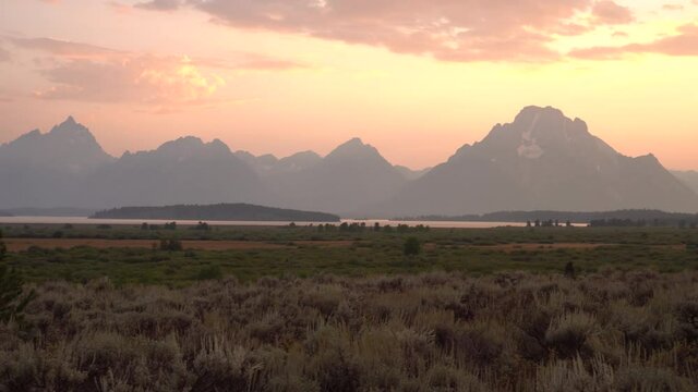 The Tetons with the sunset and ash mixture in summer 2020.