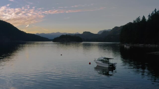 Boat Moored Over The Sechelt Inlet On The Sunshine Coast Near Egmont, Quebec On A Sunset - tracking shot