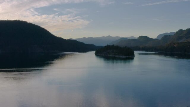 Lush Trees In Sechelt Inlet Near Egmont, British Columbia, Canada - Scenic Sunset View - slow drone shot (pullback)