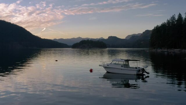 Speedboat Floating At The Sechelt Inlet On A Sunset Near The Egmont In Sunshine Coast, British Columbia, Canada. - aerial drone shot