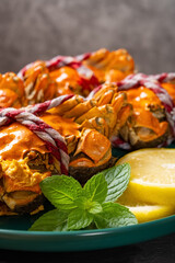 side view cooked crabs on a dish with lemon and mint leaves selective focus