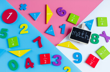 Colorful math fractions, numbers on blue pink white background. Interesting, fun mathematics for kids. Education, back to school concept	