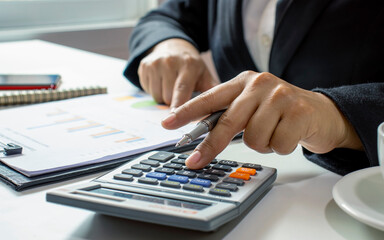 Business people or accountants who are reviewing financial documents and bank books, financial ideas and investments.