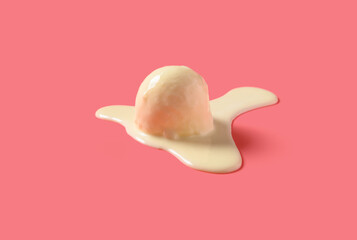 side view vanilla flavor ice cream ball in a melting process on pink background