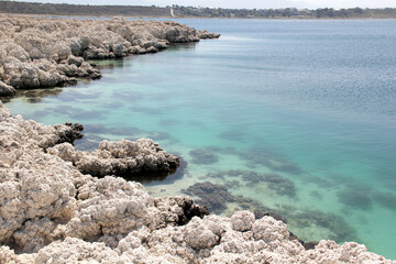 
landscape of white rock formations and body of water, lagoon of turquoise blue colors. Laguna de Alchichica, Puebla Mexico