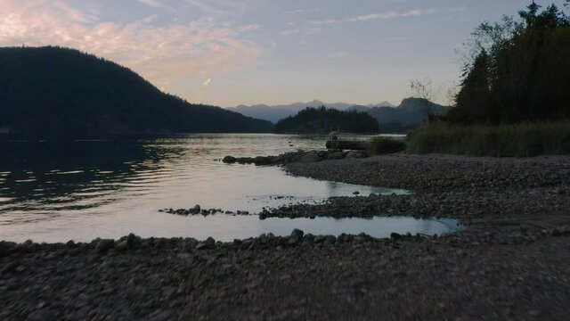 Rocky Shore Of Sechelt Inlet With A Calm Water On A Summer Sunset - A Pacific Ocean fjord On The Sunshine Coast Near Egmont, British Columbia, Canada.  - aerial drone shot