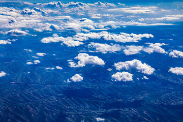 Aerial view above the clouds and mountain peaks on a sunny day.mountain view from airplane.