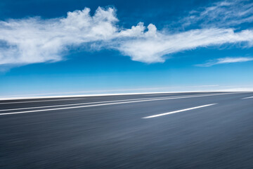 Motion blurred asphalt road and cloud scenery.