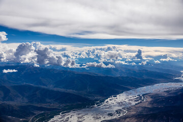 Fototapeta premium Aerial view above the river and mountain peak.mountain view from airplane.