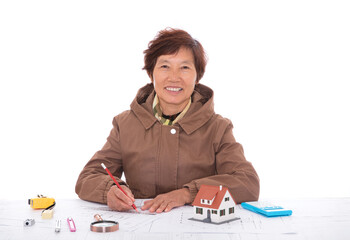 Chinese female architect at work looking up and smiling at camera