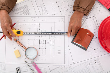Architects use tape measure to measure the accuracy of drawings