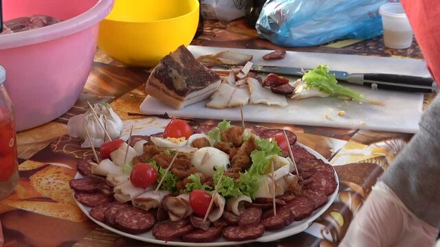 meat plate - sliced prosciutto and salami sausage on stone serving board.
Sliced smoked sausage and ham.
Tasty food served on the table.

