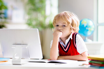 Online remote learning. School kids with computer.