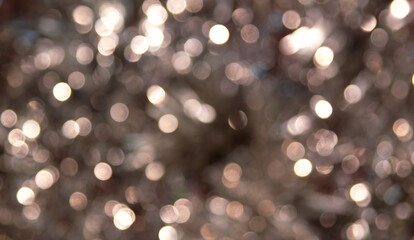 Christmas lights. Bokeh glows on a dark background. Christmas garlands with blurred focus in the form of sparks and Golden bokeh