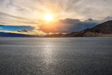 Asphalt road and mountain with sky clouds landscape at sunrise.