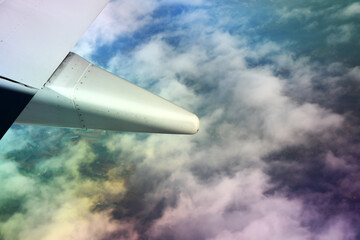 Naklejka na ściany i meble airplane flying over the clouds