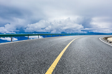 Asphalt road and mountain with sky clouds landscape.