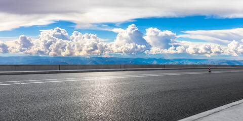 Asphalt road and mountain with sky clouds landscape.