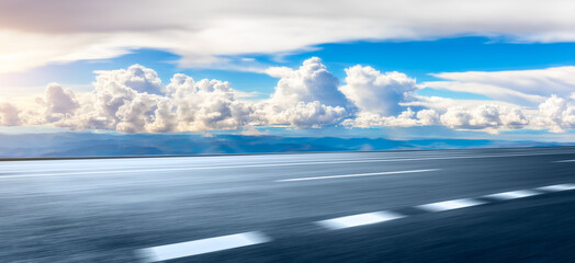 Motion blurred asphalt road and mountain with cloud scenery.