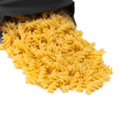 pasta close-up on a white background. Pasta spilled out of the package.
