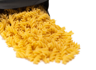 pasta close-up on a white background. Pasta spilled out of the package.
