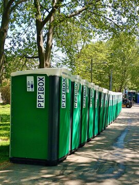 Resselpark Vienna Austria. Circa May 2016. Mobil green color toilets with unisex sign in rows in Ressel Park for the convenience of visitors for an outdoor concert. 