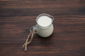 A jug of fresh milk on an old wooden table