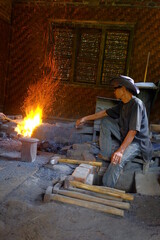 Yogyakarta / Indonesia - September 5, 2020: The process of making a keris in the forging stage of iron which is burned using fire at high temperature