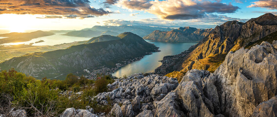 View to Kotor Bay from mountain serpentine road above the sky with clouds at sunset.
