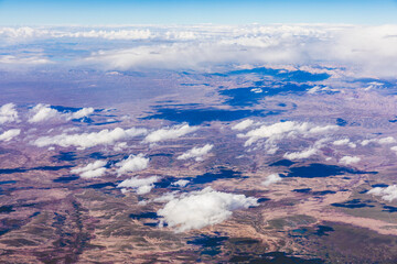 Aerial view above the clouds and mountain peaks on a sunny day.mountain view from airplane.