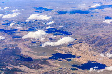 Aerial view above the clouds and mountain peaks on a sunny day.mountain view from airplane.