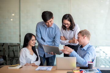 Young asian people office workers meeting and planning work together at their desk.