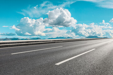 Asphalt road and mountain with sky clouds landscape.