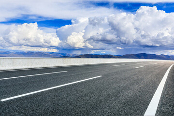 Asphalt road and mountain with sky clouds landscape.