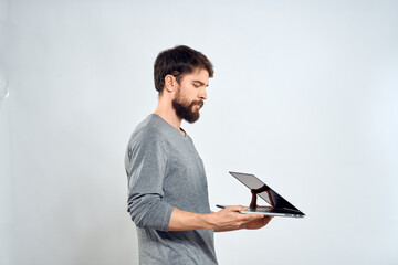 Emotional man holding a laptop success modern style work light background