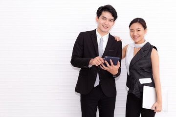 Young couple business man and woman standing with crossed hands against white background. Concept of partnership in business.