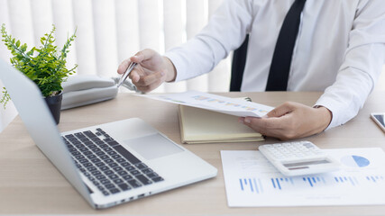 Financial businessmen analyze the graph of the company's performance to create profits and growth,...