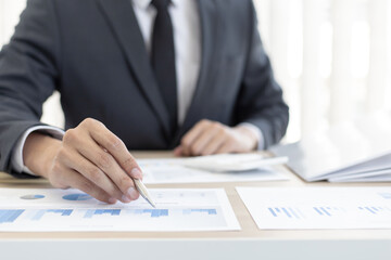 Finance workers are analyzing data in a private office.