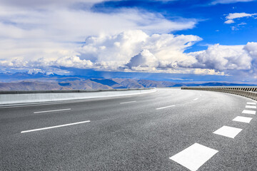 Fototapeta premium Asphalt road and mountain with sky clouds landscape.
