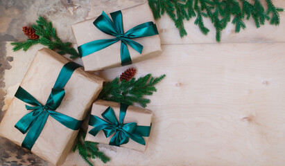 Gifts with green ribbons, Christmas tree branches.  