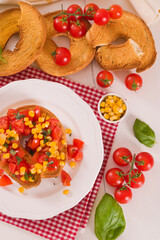 Friselle with tomatoes and mais.