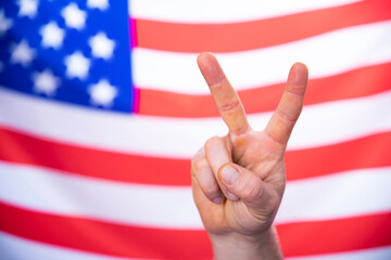 American flag with victory sign