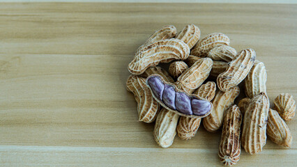 Peanuts in shells on wood background