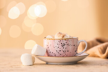 Cup of tasty cocoa drink with marshmallows on table