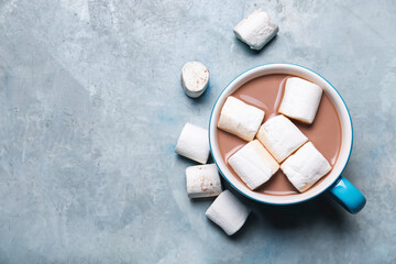 Cup of tasty cocoa drink with marshmallows on table