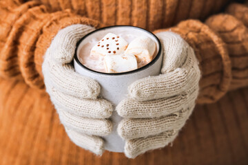 Woman with mug of tasty cocoa drink, closeup