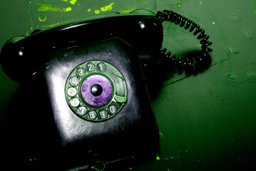 Retro style landline telephone. Vintage dial telephone with a coiled cable and a handset.