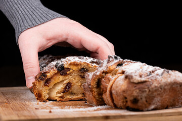 The girl raises a cut piece of homemade raisin pie.